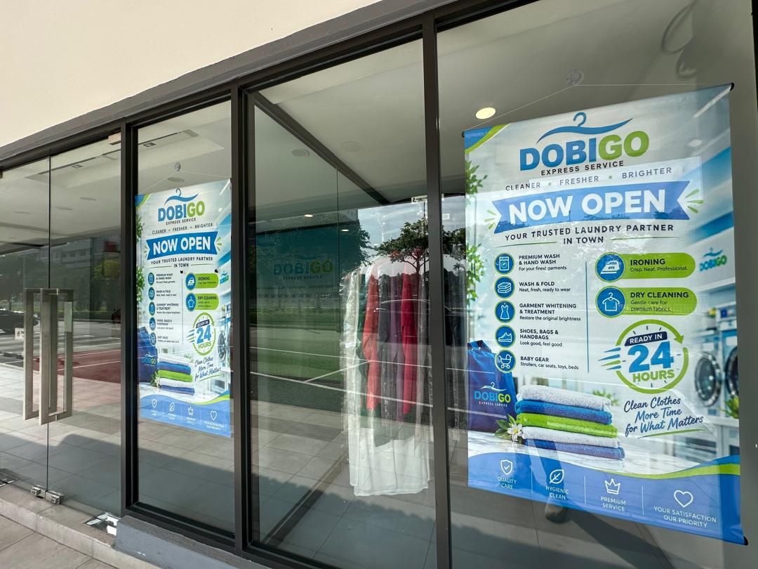 Dobigo Express "Now Open" services poster in the shop window
